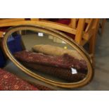 A 19th century oval gilt framed wall mirror, 36" x 22"