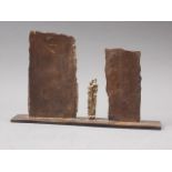 A modern patinated steel and brass figure group with monoliths, 7 1/4" high