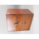 A mahogany inlaid cabinet enclosed three doors, 12" wide x 9 1/2" deep x 4 1/2" high