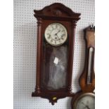 A mahogany cased wall clock with enamelled dial and Roman numerals, 26 1/2" high