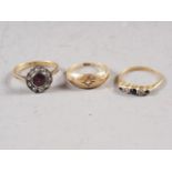 An 18ct gold diamond and garnet cluster ring, size J, 2.5g, an 18ct gold diamond and sapphire