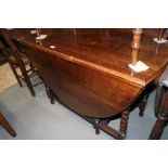 An oak oval top drop leaf dining table, on barley twist stretchered supports, 40" wide x 58" deep