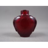 A carved red Peking glass snuff bottle, 2 5/8" high