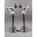 A pair of silvered plastic Art Deco Style table lamps, formed as women, on stepped bases, 24" high