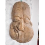 An Oriental hardwood plaque, formed as a comic character, 24 1/4" x 14 1/2"