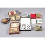 A box of Acme poker chips, cowrie shell counters, various boxed playing cards, a green onyx ashtray,