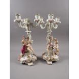 A pair of late19th century Meissen three-branch candelabra with followers of Bacchus decoration,
