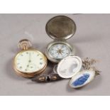 A rolled gold cased open faced pocket watch, a nickel cased pocket compass, a silver locket, on