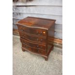 A mahogany and banded serpentine front chest of four long drawers, on bracket feet, 27 1/2" wide x