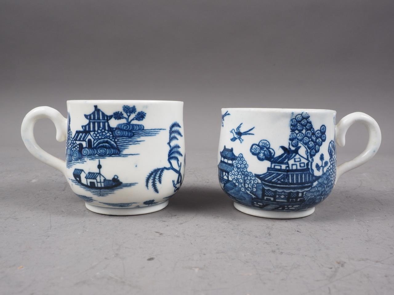 A pair of Caughley blue and white baluster cups with proto-willow pattern design, 2 1/4" high (one