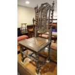 A carved oak side chair of 17th century design with panel seat and an oak framed stool with padded