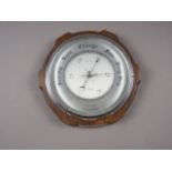 An aneroid barometer, by Shortland Smiths, in oak case, 10 1/2" dia