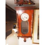 An early 20th century mahogany cased wall clock with white enamel dial and eight-day striking