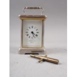 A Garrard & Co white metal and gilt five glass miniature carriage clock with white enamel dial and