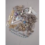 A selection of silver and white metal jewellery, including necklaces, two Albert chains, a moonstone