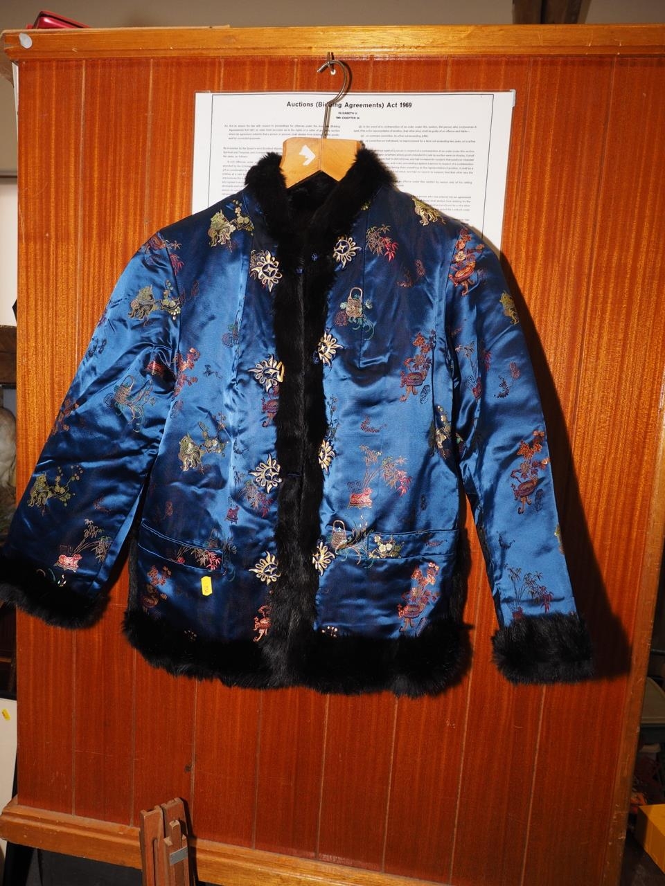 A Chinese silk and fur jacket, embroidered with mythical beast and plant designs on a blue ground, - Image 3 of 4