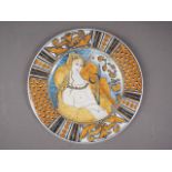 An Italian plate, decorated with a nude woman playing the violin (chip to rim)
