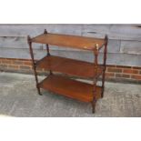 A 19th century mahogany three-tier whatnot, on turned supports and brass castors, 31" wide x 13"