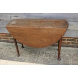 An 18th century Cuban mahogany oval drop leaf dining table, on pad feet, 20" wide x 43" deep x 28