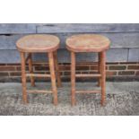 A pair of beech topped stools, on turned and stretchered supports, 26" high