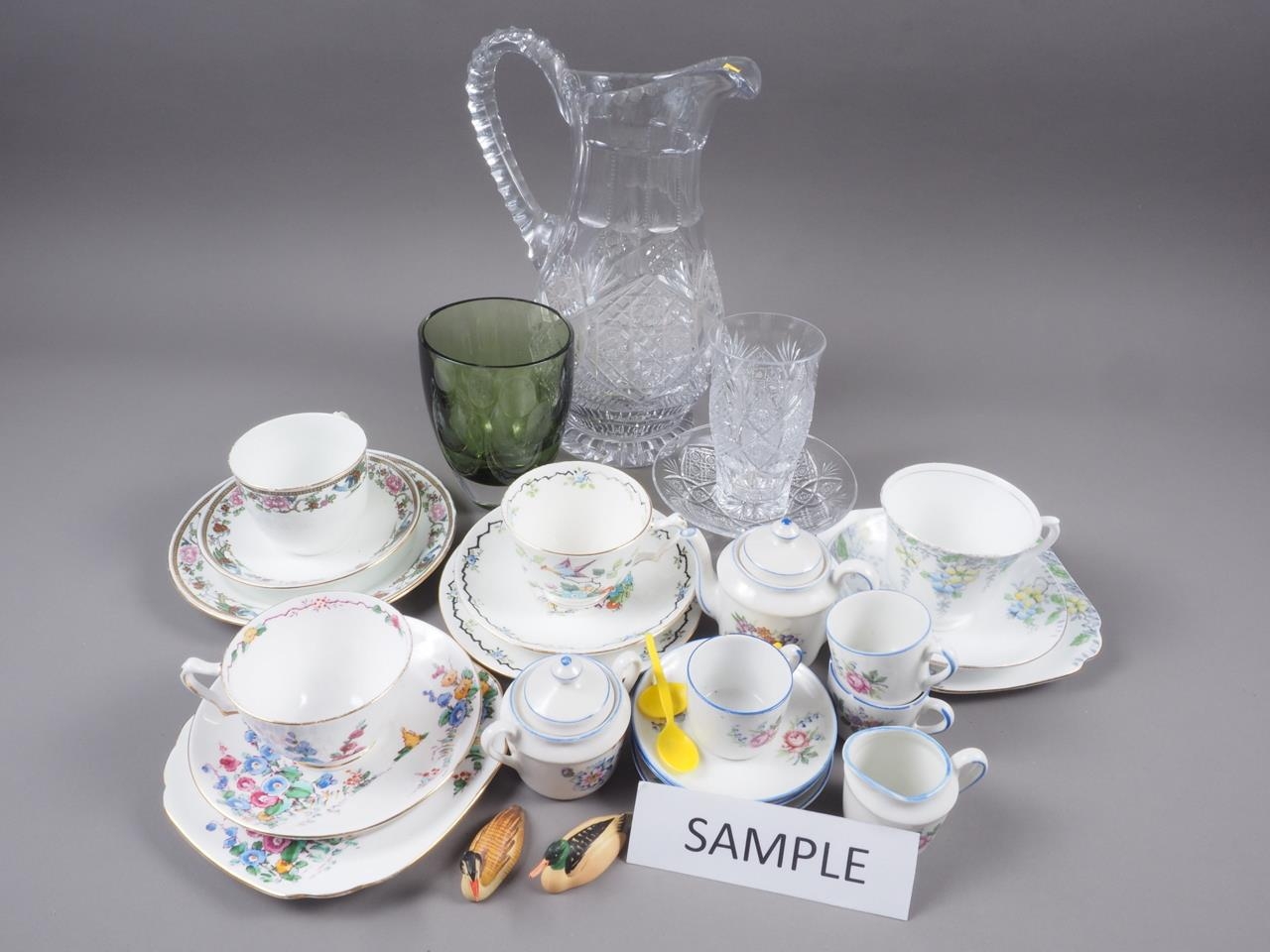 A suite of Czech cut glass, a green glass vase, bone china teacups and saucers, a group of painted