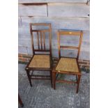 Two Edwardian walnut and line inlaid cane seat bedroom chairs, on stretchered supports
