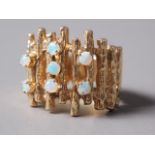 A 1970s 14ct gold and opal dress ring with textured finish and seven round opals, size N, 9.1g
