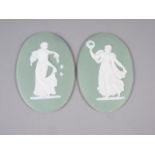 A pair of 19th century Wedgwood green jasper dip oval plaques, decorated classical figures, 6" high