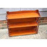 A late 19th century mahogany ledge back three-tier open wall shelf with turned pilasters, 28" wide x