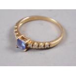 An 18ct gold, square cut sapphire and diamond dress ring, size O, 2.3g