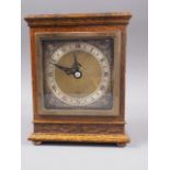 An Elliot oak cased mantel clock with engraved brass dial, 7" high