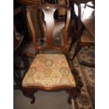 A set of eight American figured walnut dining chairs with shaped splat backs and drop-in seats (6+2)