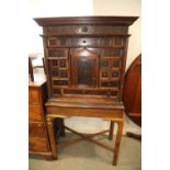 An 18th century Continental walnut and decorated cabinet of drawers, with pull out central