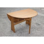 An Ercol ash oval drop leaf dining table, on gateleg supports, 42" x 48" x 28 1/2" high