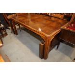 An American figured walnut and banded extending dining table with two extra leaves, on square