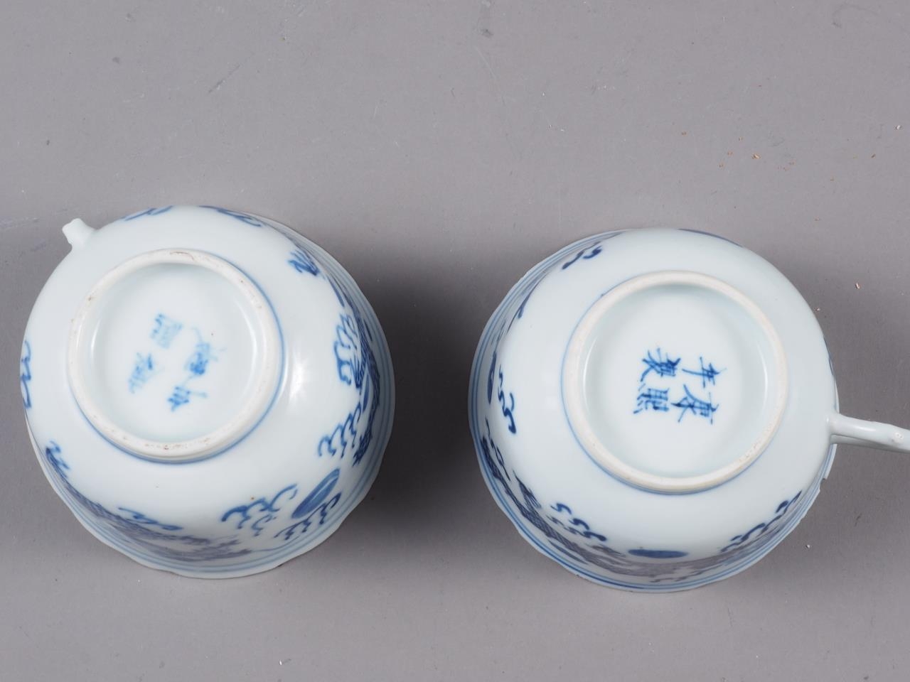 A pair of Chinese blue and white saucers, decorated with sea, dragons and flaming pearl, four- - Image 2 of 3