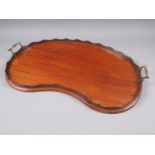 A late 19th century mahogany kidney-shaped gallery tray with brass handles, 24" wide (damages to