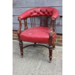An oak and red studded leather tub chair with pierced splats, fluted supports and crinoline