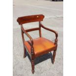 A 19th century mahogany armchair with brown leather upholstered seat, on turned supports