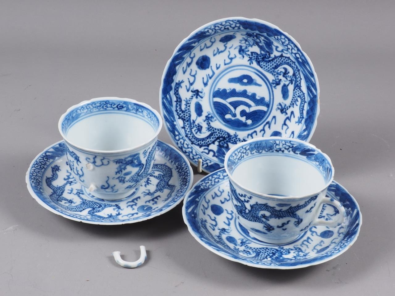 A pair of Chinese blue and white saucers, decorated with sea, dragons and flaming pearl, four-