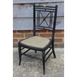 A Child's Aesthetic style ebonised chair with needlepoint seat, on turned and stretchered supports