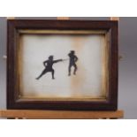 An early 19th century cut paper silhouette, figures fencing, in oak strip frame