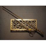 A brass trivet stand, 11 3/4" wide, a pair of brass fire tongs and a similar fire poker