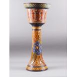 A glazed pottery pedestal jardiniere with floral decoration, 27 1/2" high
