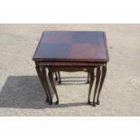 A nest of three polished as mahogany occasional tables, on cabriole supports, two other occasional