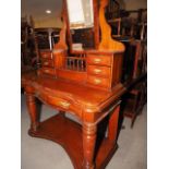 A late 19th century mahogany serpentine fronted Duchesse dressing table with shape top bevelled