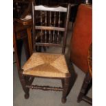 A set of three Lancashire oak spindle back chairs with rush envelope seats