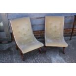 A pair of showframe nursing chairs, upholstered in a cream velour, on splayed supports, and a