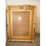 An ornate gilt picture frame, 29" x 24", and two similar frames