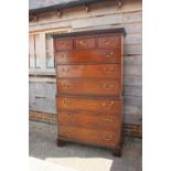 A George III figured mahogany chest on chest with dentil cornice over three short and six long